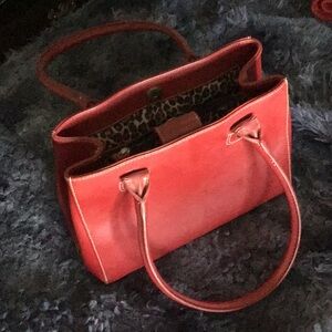 Real leather, red, and Cheetah print pockets.